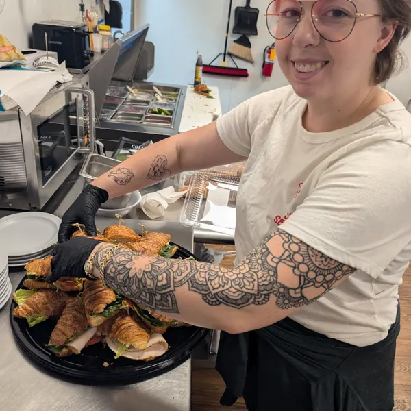 A Beanchain worker bringing out a tray of food.